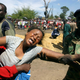 A Zambian soldier (R) and a relative comforts a wailing woman during the funeral of the 51 workers who died in a blast accident at BGRIMM Explosives Plant in the Chambishi copper mine, 400 km (250 miles) north of Zambia’s capital Lusakai, April 25, 2005.